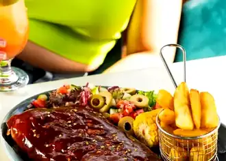 Grilled ribs with fries and salad